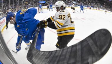 Dec 9, 2025; St. Louis, Missouri, USA; St. Louis Blues defenseman Colton Parayko (55) and Boston Bruins center Marat Khusnutdinov (92) battle for the puck during the third period at Enterprise Center. Mandatory Credit: Jeff Curry-Imagn Images