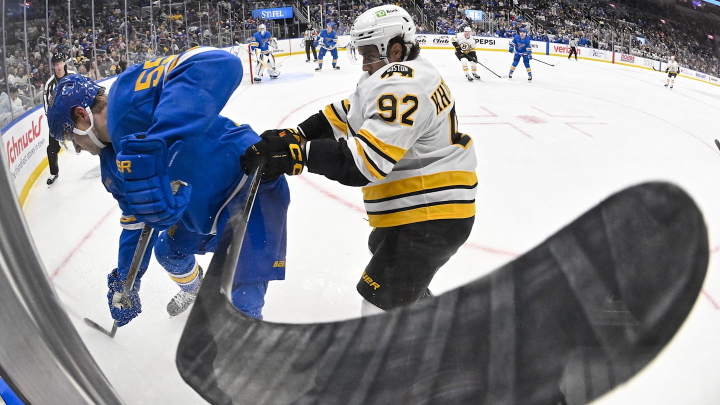 Dec 9, 2025; St. Louis, Missouri, USA; St. Louis Blues defenseman Colton Parayko (55) and Boston Bruins center Marat Khusnutdinov (92) battle for the puck during the third period at Enterprise Center. Mandatory Credit: Jeff Curry-Imagn Images