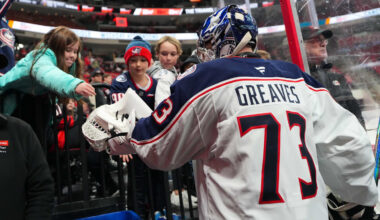 Blue Jackets goalie Jet Greaves gives a fan a puck after warmups