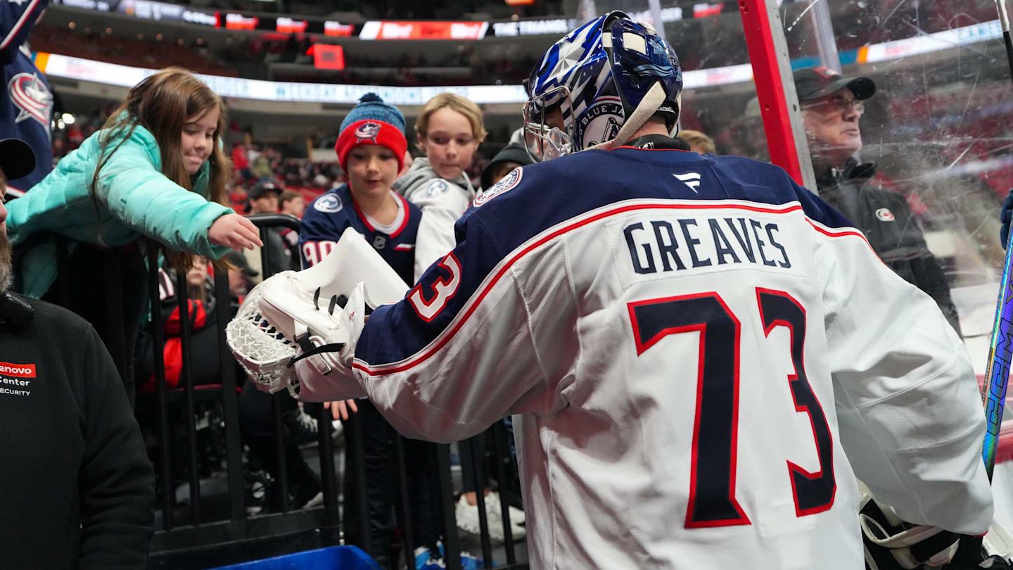 Blue Jackets goalie Jet Greaves gives a fan a puck after warmups