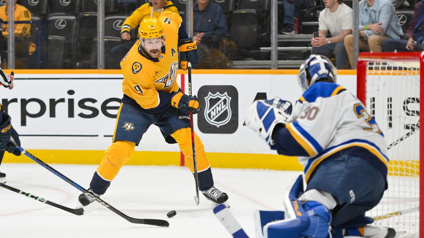 Mar 27, 2025; Nashville, Tennessee, USA;  St. Louis Blues goaltender Joel Hofer (30) blocks the shot of Nashville Predators left wing Filip Forsberg (9) during the third period at Bridgestone Arena. Mandatory Credit: Steve Roberts-Imagn Images