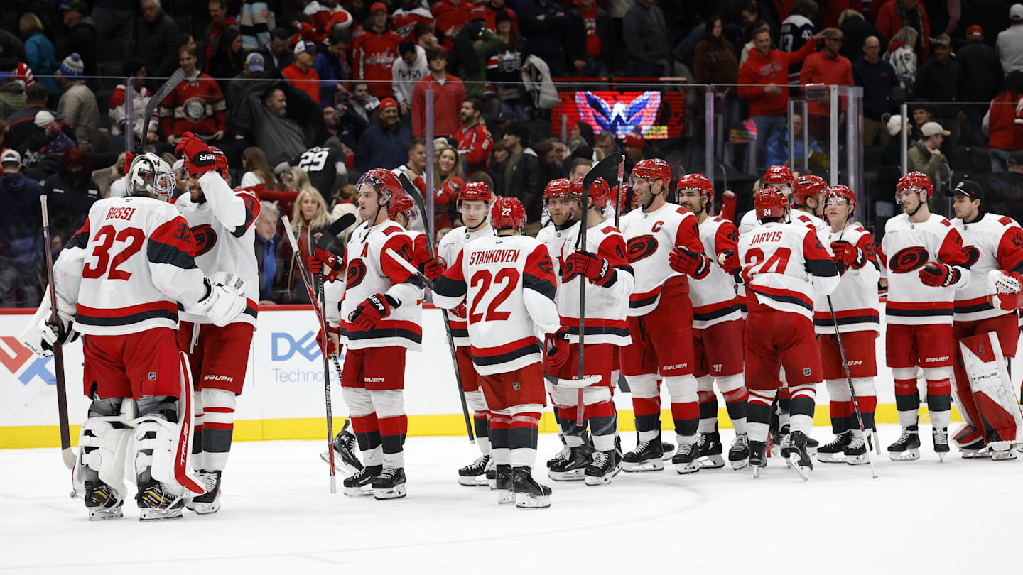 Dec 11, 2025; Washington, District of Columbia, USA; Carolina Hurricanes goaltender Brandon Bussi (32) celebrates with teammates after their game against the Washington Capitals at Capital One Arena. Mandatory Credit: Geoff Burke-Imagn Images