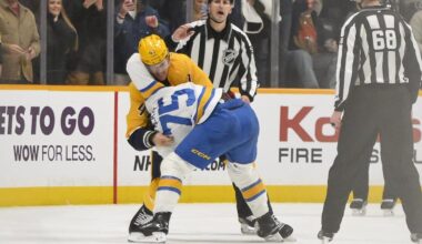 Dec 11, 2025; Nashville, Tennessee, USA;  St. Louis Blues defenseman Tyler Tucker (75) and Nashville Predators right wing Michael McCarron (47) exchange blows during the second period at Bridgestone Arena. Mandatory Credit: Steve Roberts-Imagn Images
