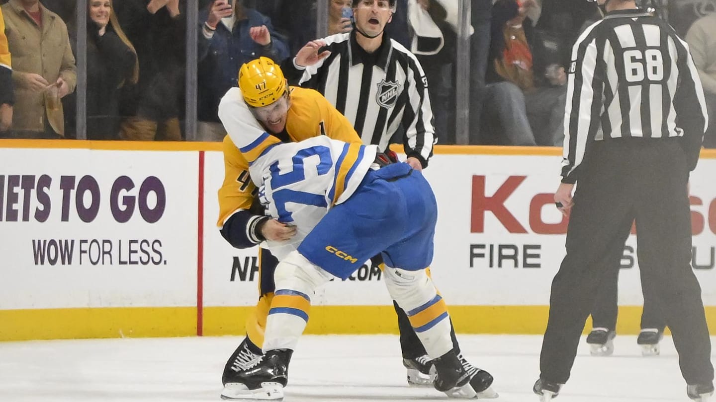 Dec 11, 2025; Nashville, Tennessee, USA;  St. Louis Blues defenseman Tyler Tucker (75) and Nashville Predators right wing Michael McCarron (47) exchange blows during the second period at Bridgestone Arena. Mandatory Credit: Steve Roberts-Imagn Images