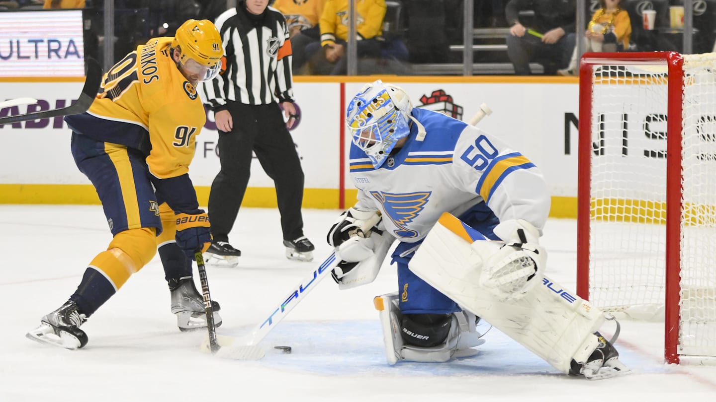 Dec 11, 2025; Nashville, Tennessee, USA;  St. Louis Blues goaltender Jordan Binnington (50) blocks the shot of Nashville Predators center Steven Stamkos (91) during the first period at Bridgestone Arena. Mandatory Credit: Steve Roberts-Imagn Images