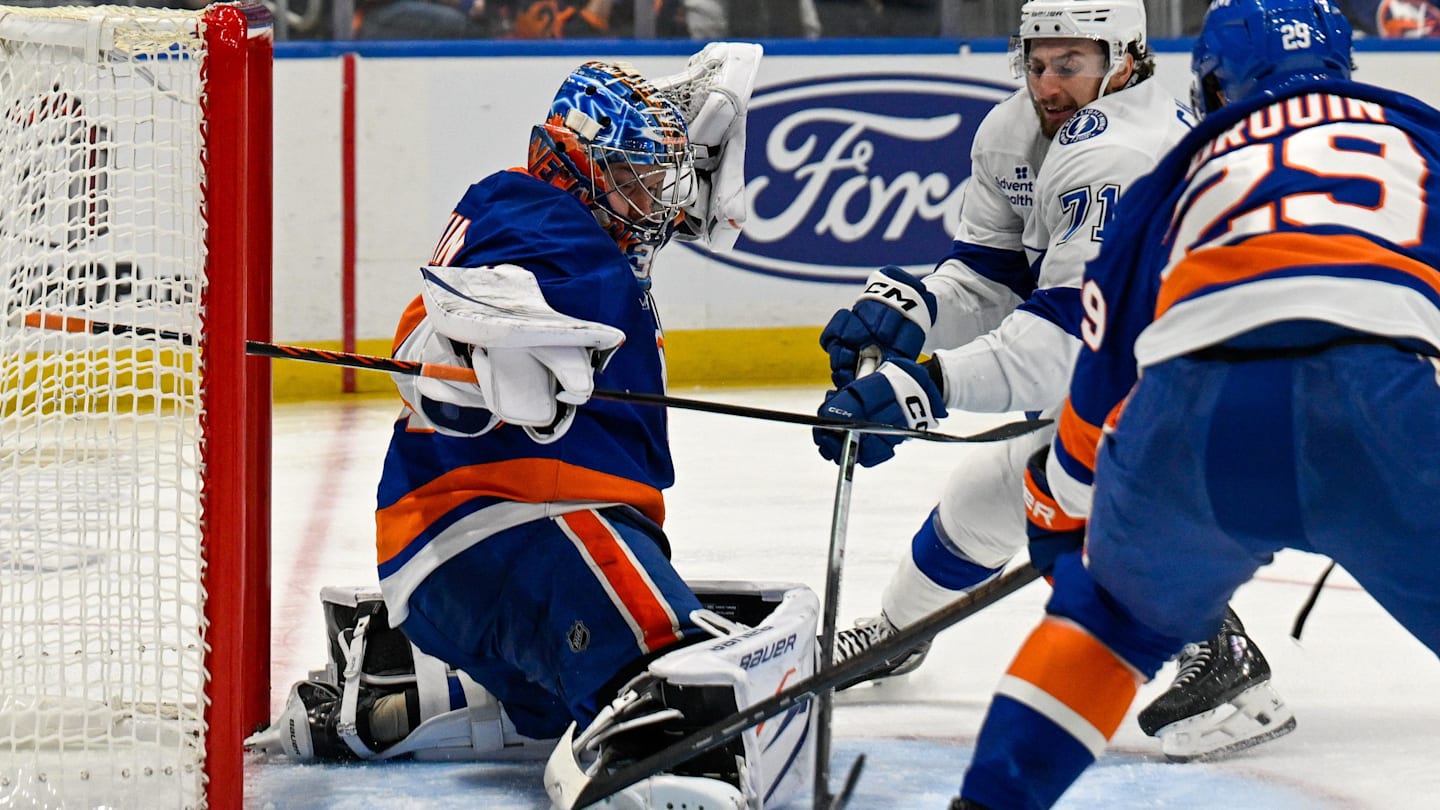 Dec 13, 2025; Elmont, New York, USA; New York Islanders goaltender Ilya Sorokin (30) makes a save on Tampa Bay Lightning center Anthony Cirelli (71) defended by New York Islanders left wing Jonathan Drouin (29) during during the third period at UBS Arena. Mandatory Credit: Dennis Schneidler-Imagn Images
