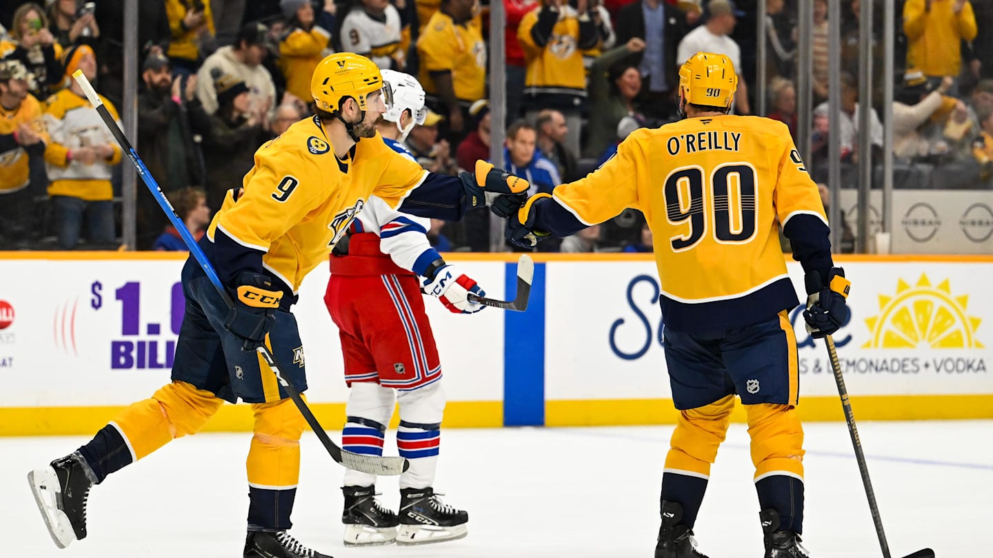 Dec 21, 2025; Nashville, Tennessee, USA;  Nashville Predators left wing Filip Forsberg (9) and center Ryan O'Reilly (90) celebrate the win during the third period at Bridgestone Arena. Mandatory Credit: Steve Roberts-Imagn Images