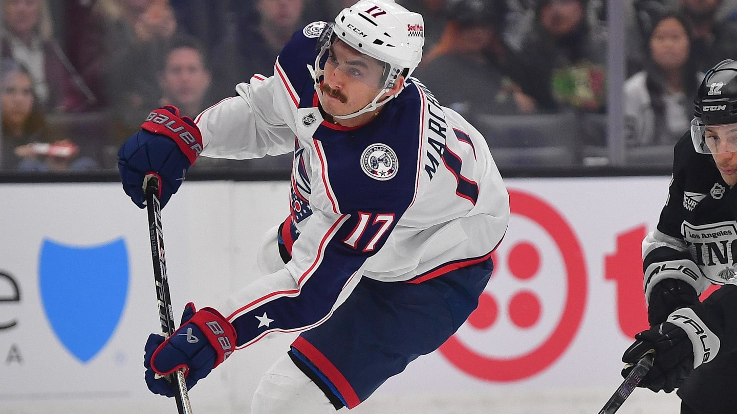 Dec 22, 2025; Los Angeles, California, USA; Columbus Blue Jackets left wing Mason Marchment (17) scores a goal ahead of Los Angeles Kings left wing Trevor Moore (12) during the first period at Crypto.com Arena. Mandatory Credit: Gary A. Vasquez-Imagn Images