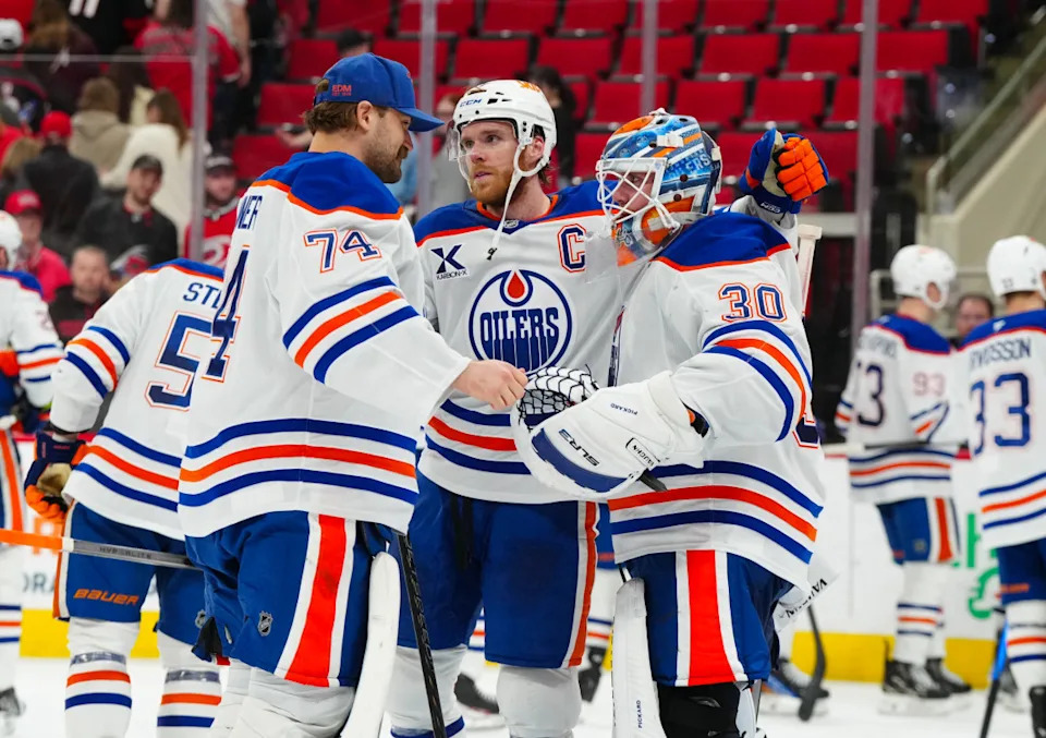 Edmonton Oilers goaltender Calvin Pickard (30) celebrates a victory with center Connor McDavid (97) and goaltender Stuart Skinner (74) against the Carolina Hurricanes.James Guillory-Imagn Images