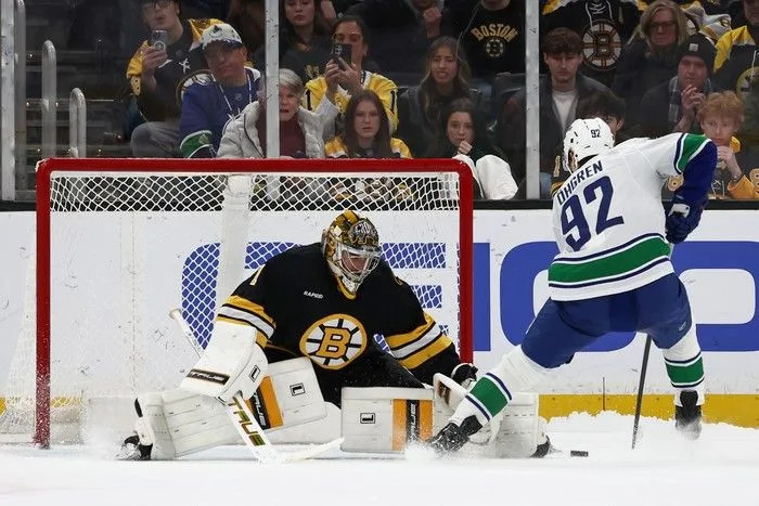  Liam Ohgren of the Vancouver Canucks scores the only goal in a seven-round shootout on Jeremy Swayman of the Boston Bruins at TD Garden on Dec. 20, 2025 in Boston.