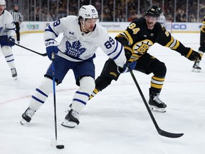Nick Robertson of the Toronto Maple Leafs skates against Tanner Jeannot of the Boston Bruins during a game last week.