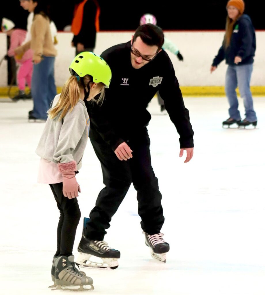 KINGS FOR A DAY—A member of the club works with a young skating hopeful. Courtesy of Katherine Stayer/L.A. Kings