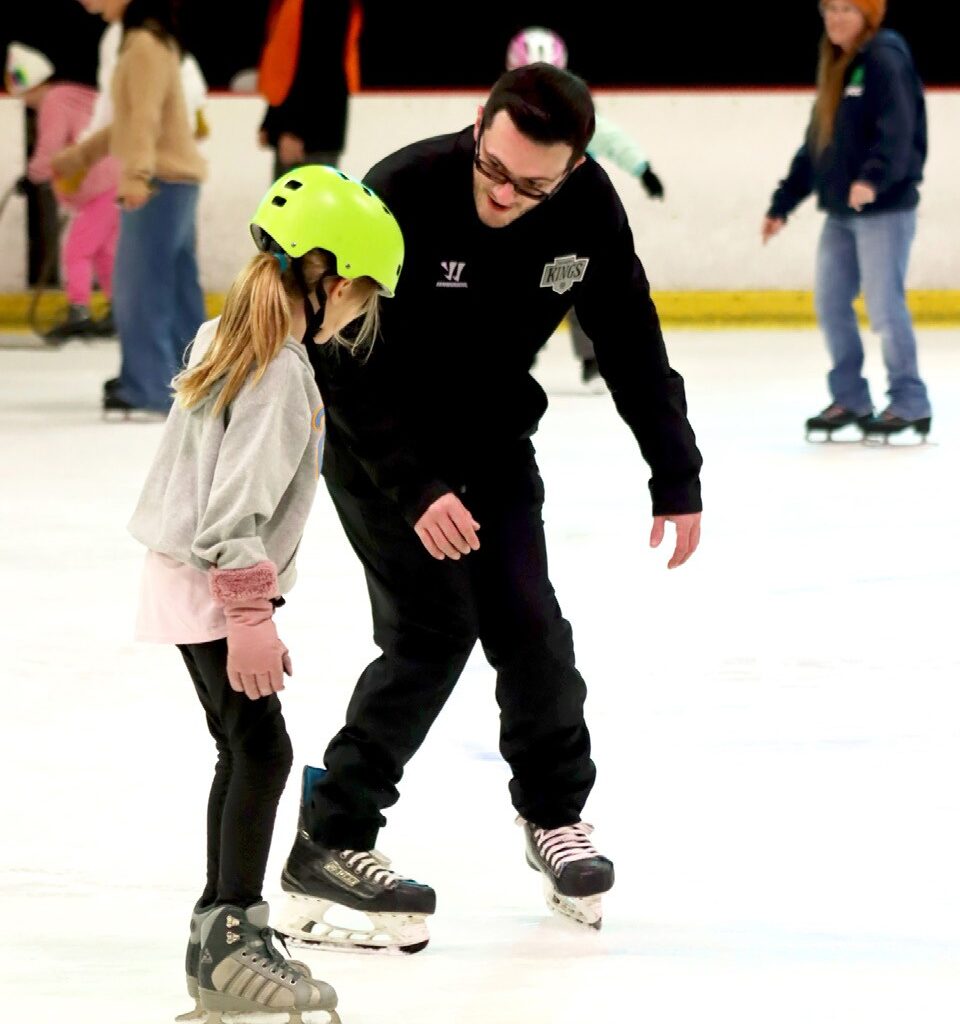 KINGS FOR A DAY—A member of the club works with a young skating hopeful. Courtesy of Katherine Stayer/L.A. Kings