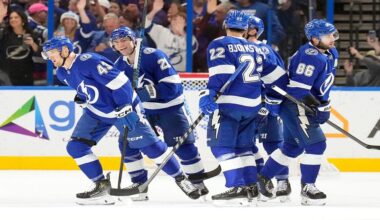 Tampa Bay Lightning defenseman Darren Raddysh (43) celebrates his goal against the St. Louis Blues with teammates, including center Brayden Point (21), right wing Oliver Bjorkstrand (22) and right wing Nikita Kucherov (86) during the first period of an NHL hockey game Monday, Dec. 22, 2025, in Tampa, Fla. (AP Photo/Chris O'Meara)
