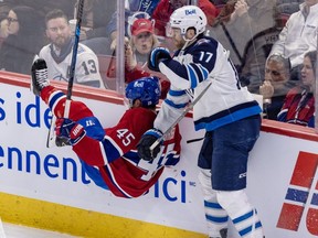 Adam Lowry checks Alexandre Carrier