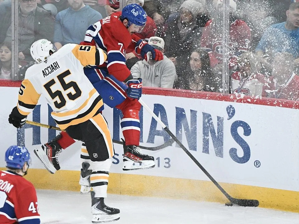  Pittsburgh Penguins’ Noel Acciari (55) checks Canadiens’ Arber Xhekaj (72) against the boards in Montreal on Saturday, Dec. 20, 2025.
