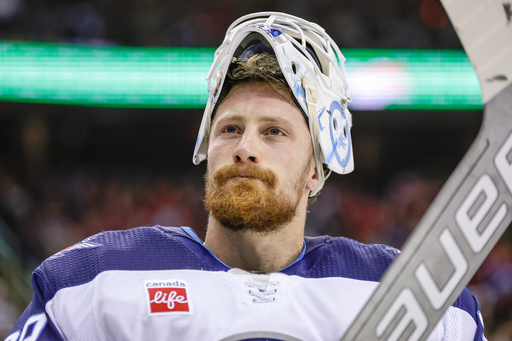 FILE - Winnipeg Jets goaltender Laurent Brossoit (39) reacts against the New Jersey Devils during the second period of an NHL hockey game March 21, 2024, in Newark, N.J. (AP Photo/Adam Hunger, File)