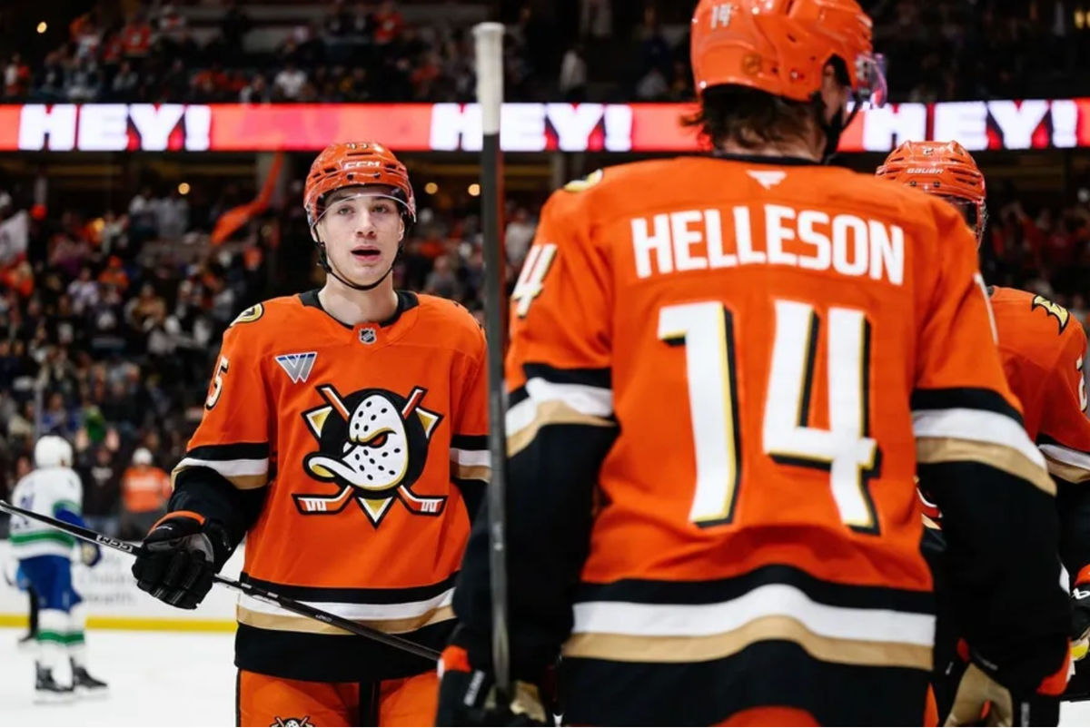 Nov 26, 2025; Anaheim, California, USA; Anaheim Ducks right wing Beckett Sennecke (45), left, looks on after assisting on a goal during the second period against the Vancouver Canucks at Honda Center. Mandatory Credit: William Liang-Imagn Images