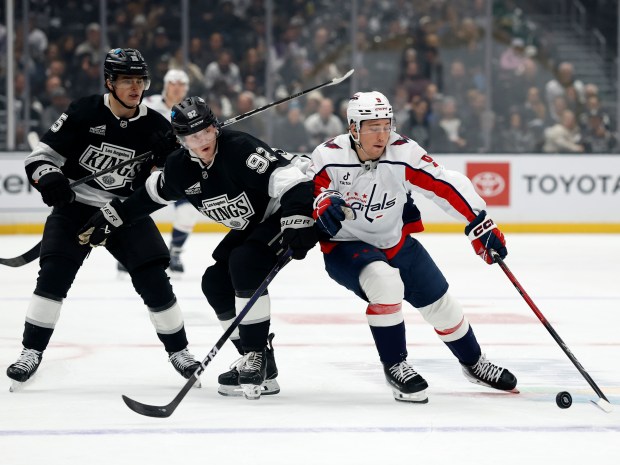 The Washington Capitals’ Ryan Leonard, right, controls the puck as...