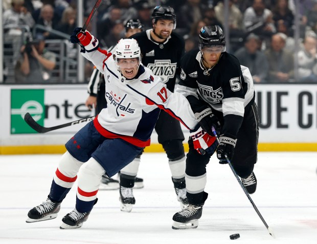 The Kings’ Quinton Byfield, right, dekes the Washington Capitals’ Dylan...