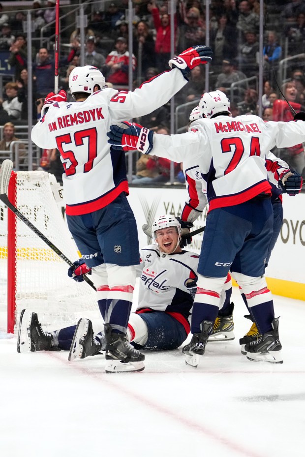Washington Capitals left wing Anthony Beauvillier, below, celebrates his goal...