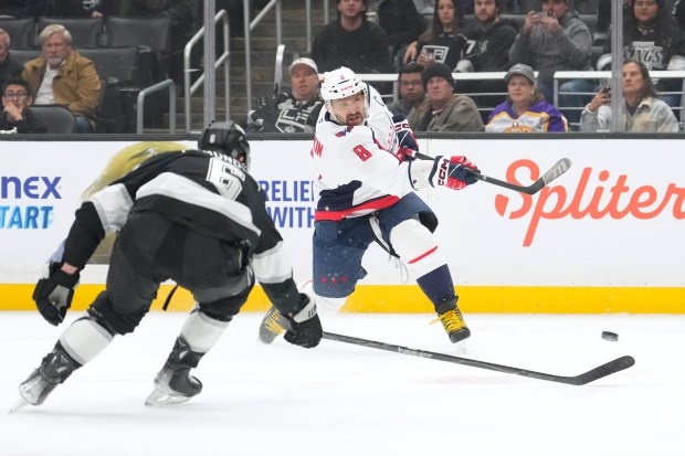 Washington Capitals left wing Alex Ovechkin, right, shoots as Kings...
