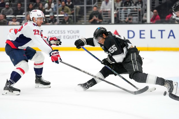 Kings right wing Quinton Byfield, right, attempts a shot as...