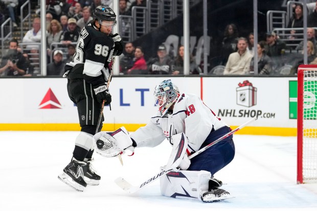 Washington Capitals goaltender Logan Thompson, right, makes a glove save...