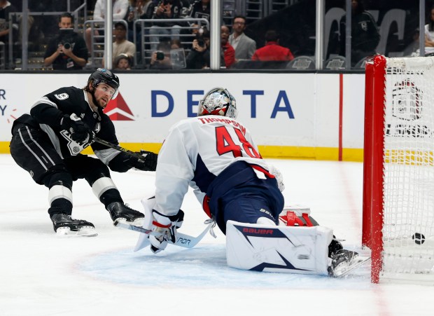 The Kings’ Adrian Kempe, left, scores a game-tying goal past...