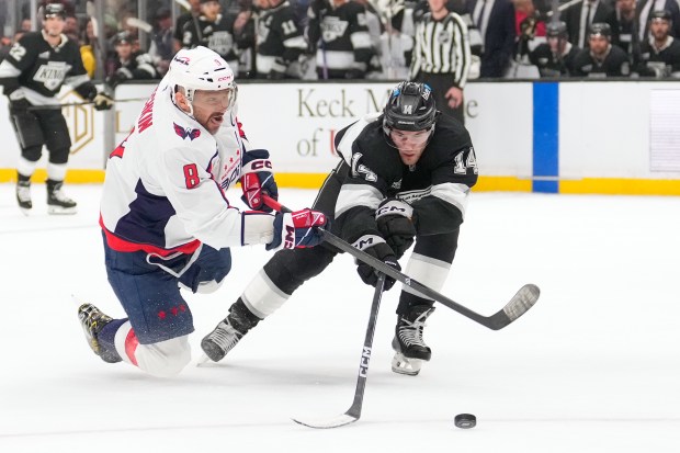 Washington Capitals left wing Alex Ovechkin, left, shoots the puck...