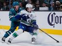 Vancouver Canucks defenceman Quinn Hughes gives San Jose Sharks winger Collin Graf coverage fits during a Nov. 28 game in San Jose.