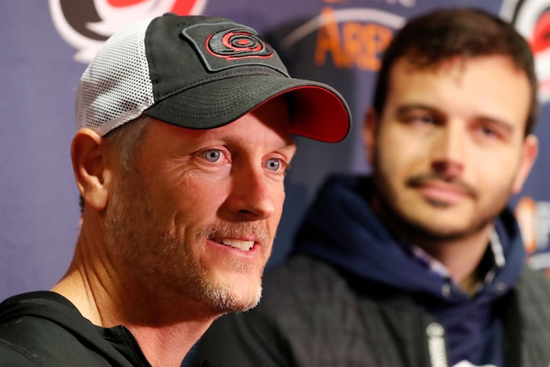 Tom Dundon, left, owner of the Carolina Hurricanes, and Charlie Ebersol, of the Alliance of American Football, speak to media before an NHL game against the New York Rangers.