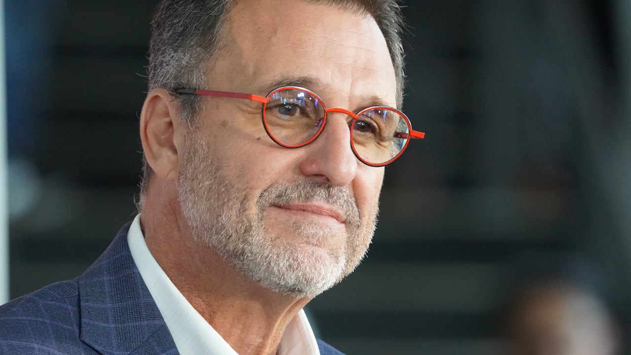 A hockey team owner gives a news conference.