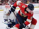 Anton Lundell #15 of the Florida Panthers faces off against Max Domi #11 of the Toronto Maple Leafs during the first period at Amerant Bank Arena in Sunrise, Florida. 
