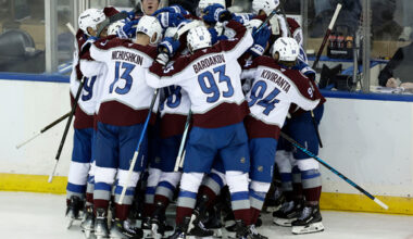 Colorado Avalanche center Nathan MacKinnon (29) is surrounded by teammates after scoring the game-winning goal in overtime of an NHL hockey game against the New York Rangers, Saturday, Dec. 6, 2025, in New York. (AP Photo/Adam Hunger)