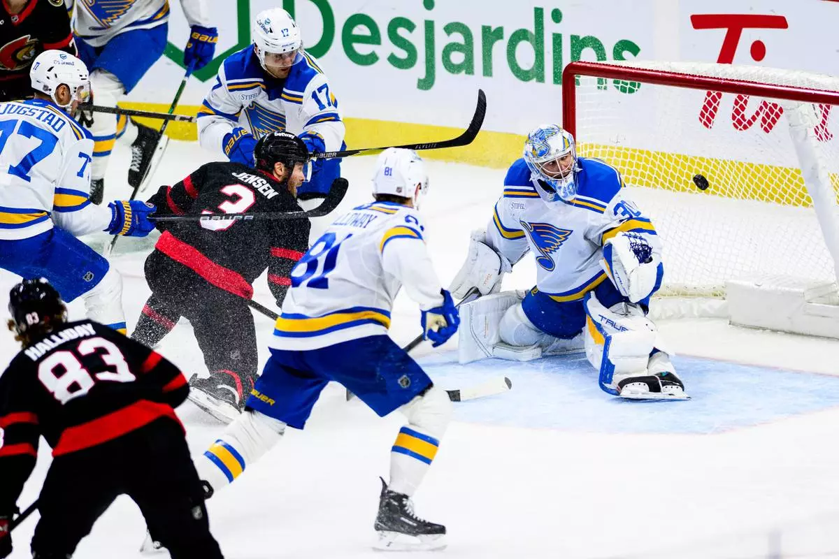 St. Louis Blues goaltender Joel Hofer (30) watches the puck from a shot by Ottawa Senators' Nick Jensen (3) during the third period of an NHL hockey game in Ottawa, Ontario, Saturday, Dec. 6, 2025. (Spencer Colby/The Canadian Press via AP)