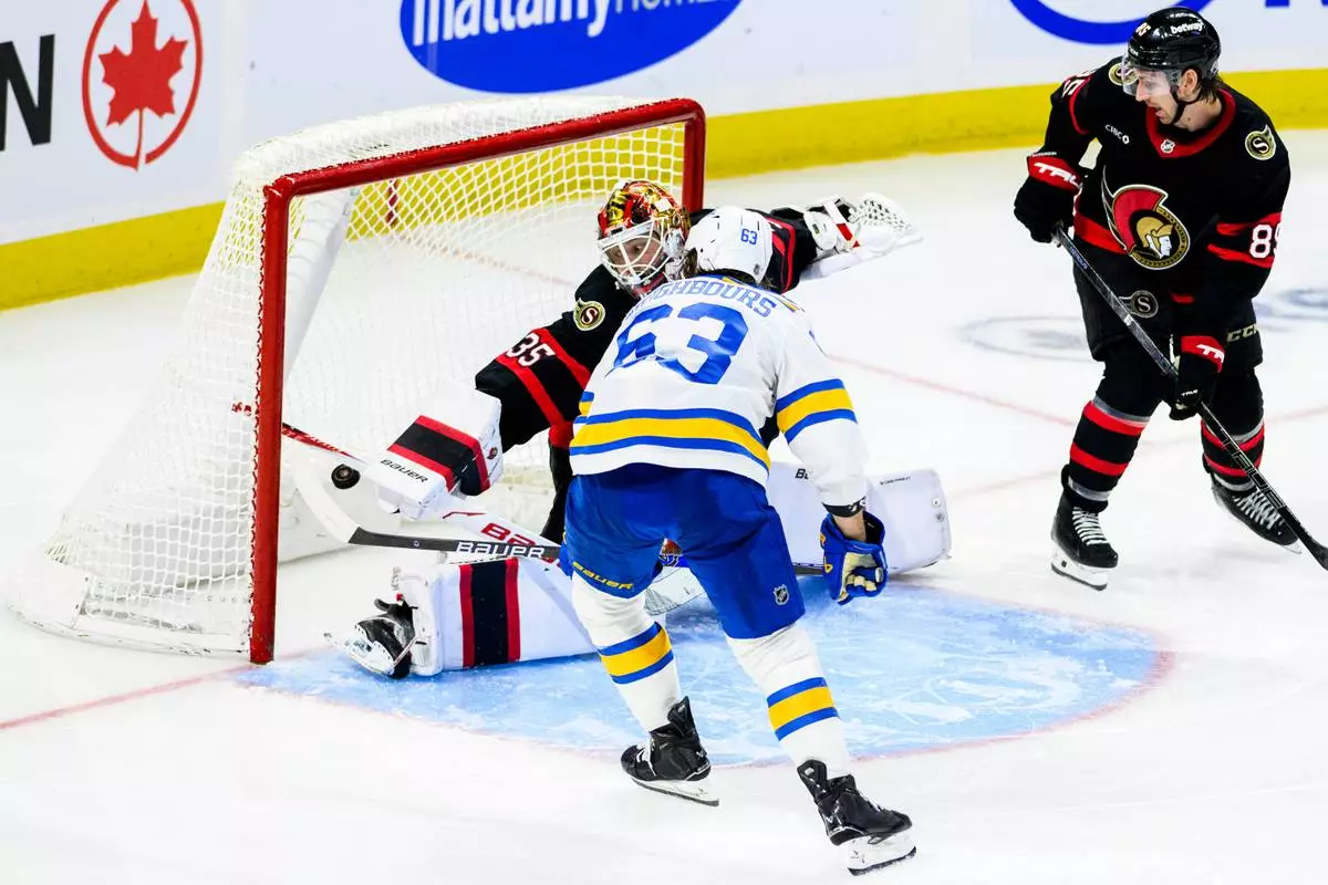 St. Louis Blues' Jake Neighbours (63) scores on Ottawa Senators goaltender Linus Ullmark (35) during the third period of an NHL hockey game in Ottawa, Ontario, Saturday, Dec. 6, 2025. (Spencer Colby/The Canadian Press via AP)