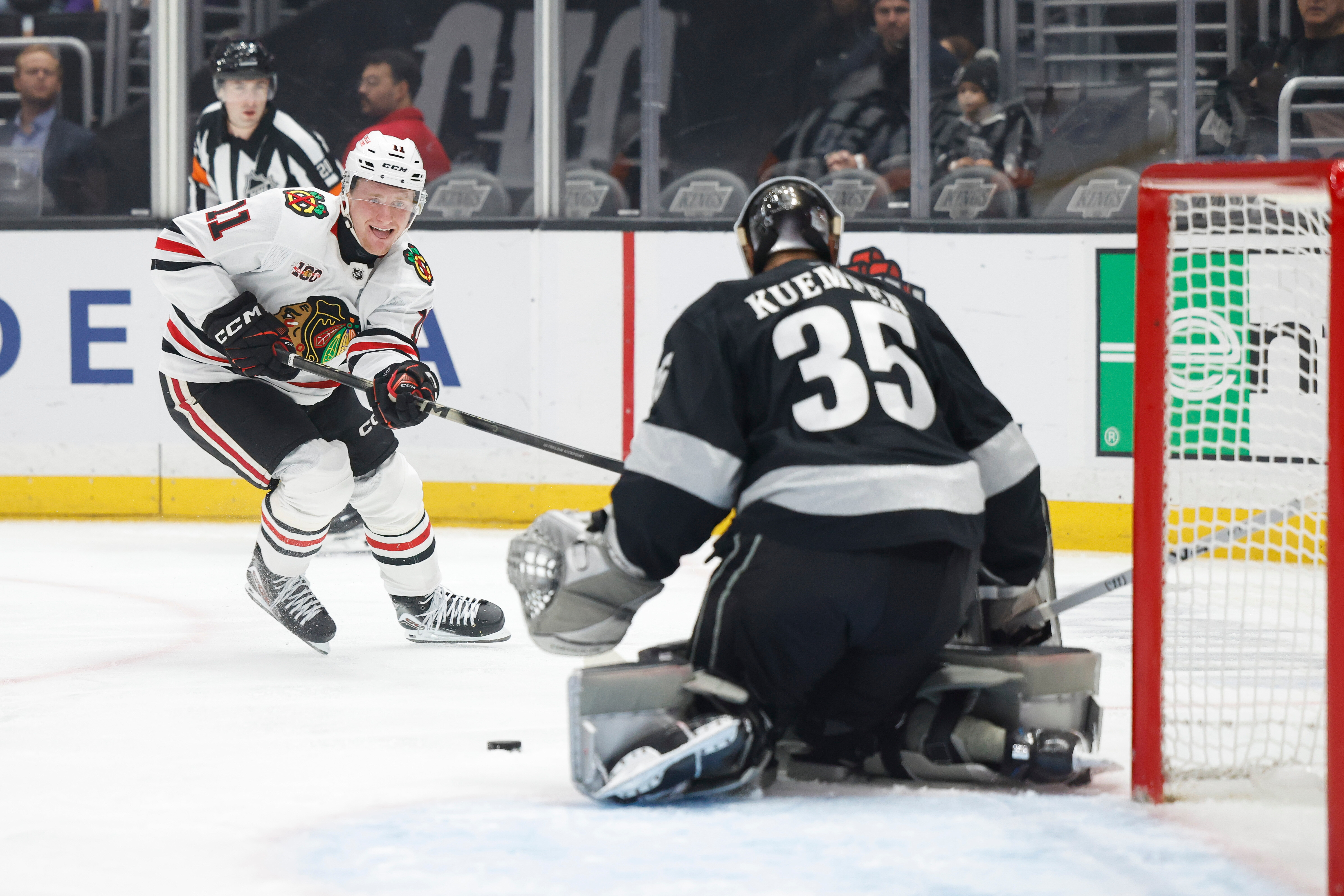 Chicago Blackhawks center Oliver Moore (11) shoots against Kings goaltender...