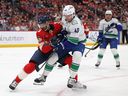 Seth Jones of the Florida Panthers checks Elias Pettersson of the Vancouver Canucks during third period on Nov. 17 in Sunrise, Fla.