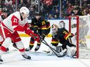 Detroit Red Wings' James van Riemsdyk (21) scores on Kevin Lankinen (32) as Marcus Pettersson (29) defends during the first period at Rogers Arena on Monday night