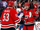 Carolina Hurricanes' Nikolaj Ehlers (27) celebrates his goal with Jackson Blake this season.

