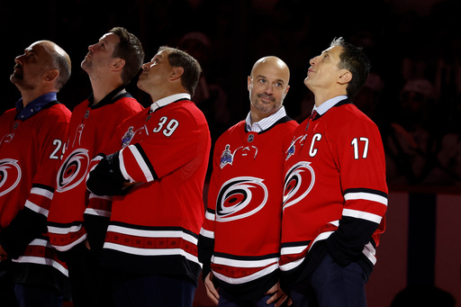 The 2005-06 Stanley Cup Champion Chad LaRose, second right, watches a video with teammate Rod Brind