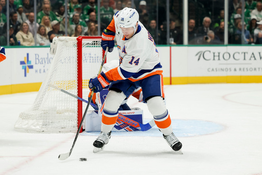 New York Islanders center Bo Horvat controls the puck during the first period of an NHL hockey game against the Dallas Stars, Tuesday, Nov. 18, 2025, in Dallas. (AP Photo/Gareth Patterson)