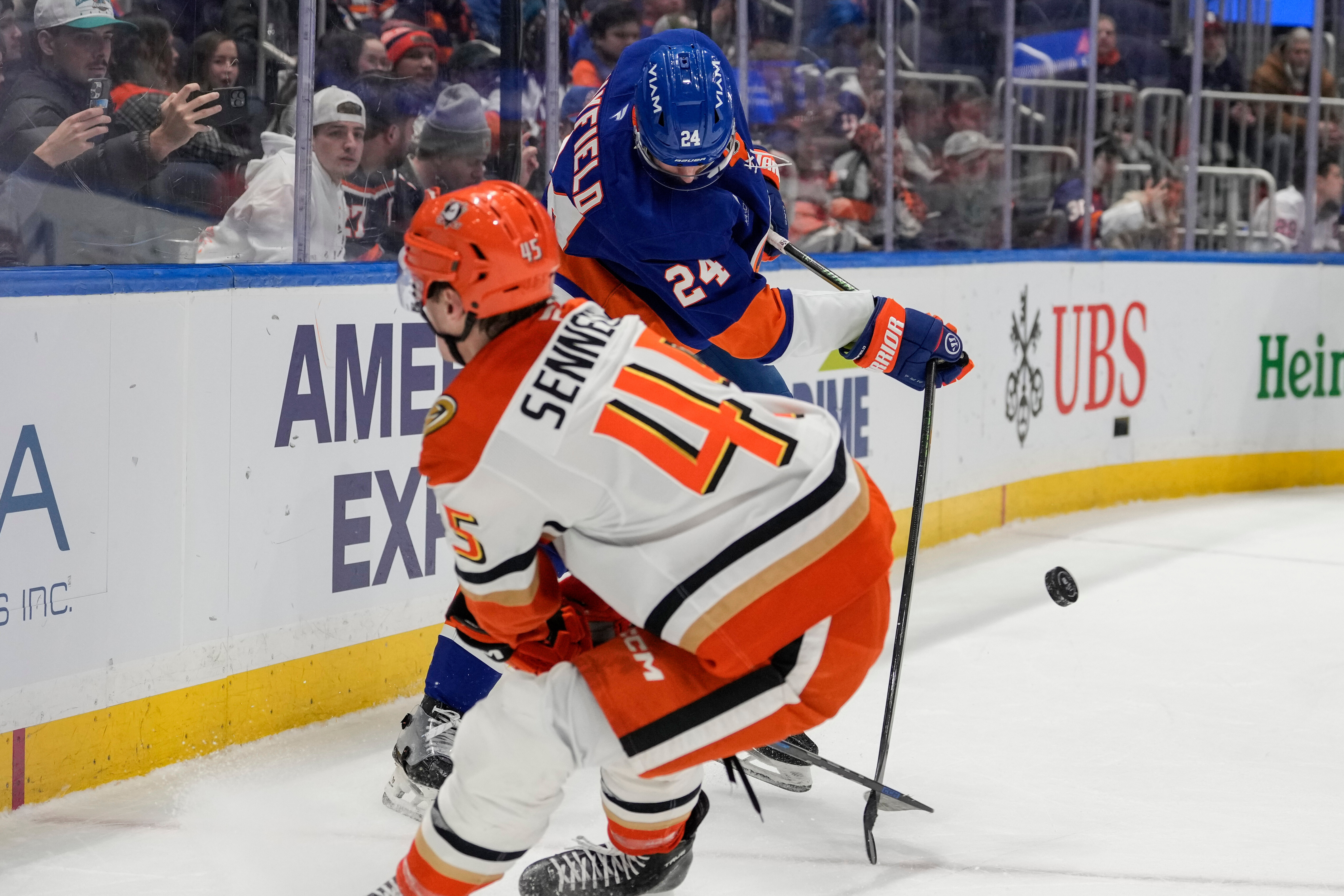 New York Islanders defenseman Scott Mayfield (24) battles for control...