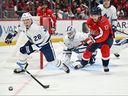Troy Stecher #28 of the Toronto Maple Leafs loses his stick after taking a slash from Dylan Strome #17 of the Washington Capitals in the second period on Thursday.

