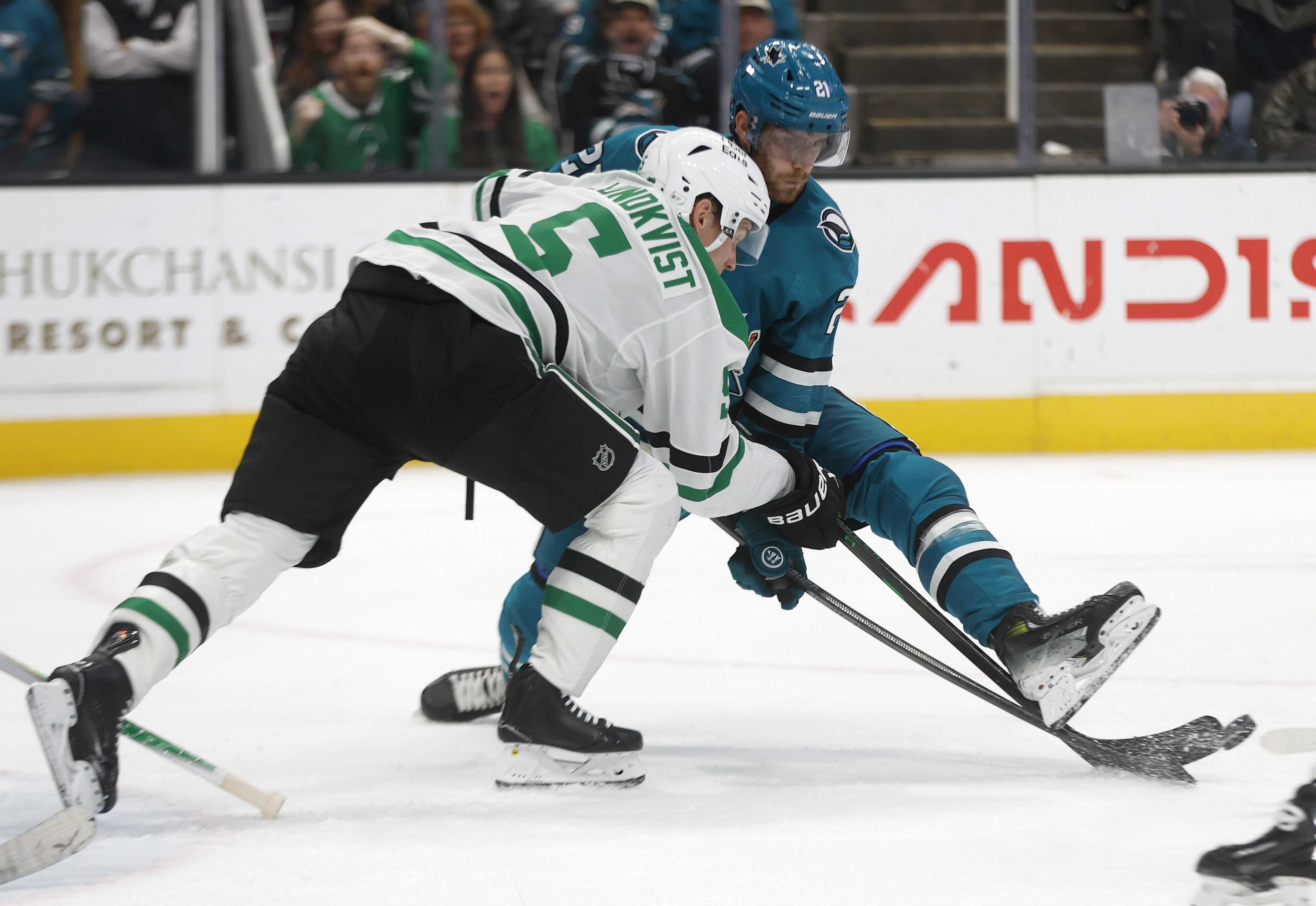 San Jose Sharks' Alexander Wennberg (21) fights for the puck...