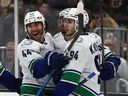 Vancouver Canucks winger Linus Karlsson is congratulated by Kiefer Sherwood after scoring his first of two goals Saturday against the Bruins in Boston.