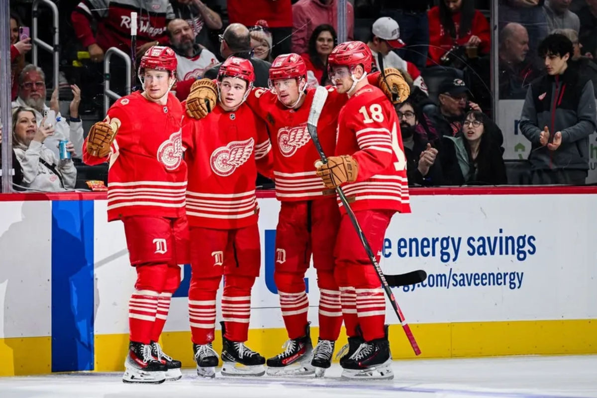 Dec 21, 2025; Detroit, Michigan, USA; Detroit Red Wings left wing Lucas Raymond (23) celebrates his goal with center Nate Danielson (29) defenseman Axel Sandin-Pellikka (44) and center Andrew Copp (18) during the second period against the Washington Capitals at Little Caesars Arena. Mandatory Credit: Tim Fuller-Imagn Images