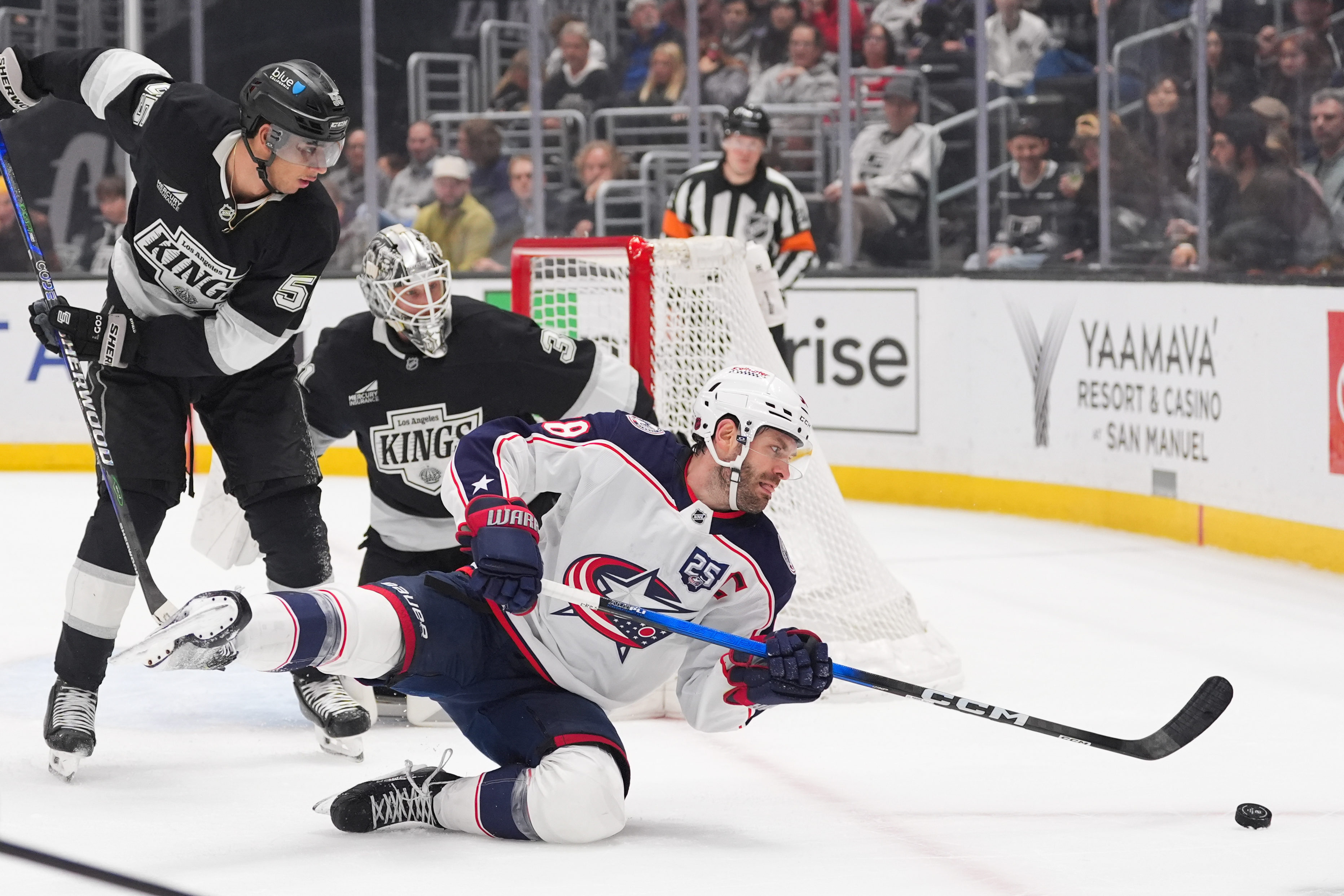 Columbus Blue Jackets center Boone Jenner falls to the ice...