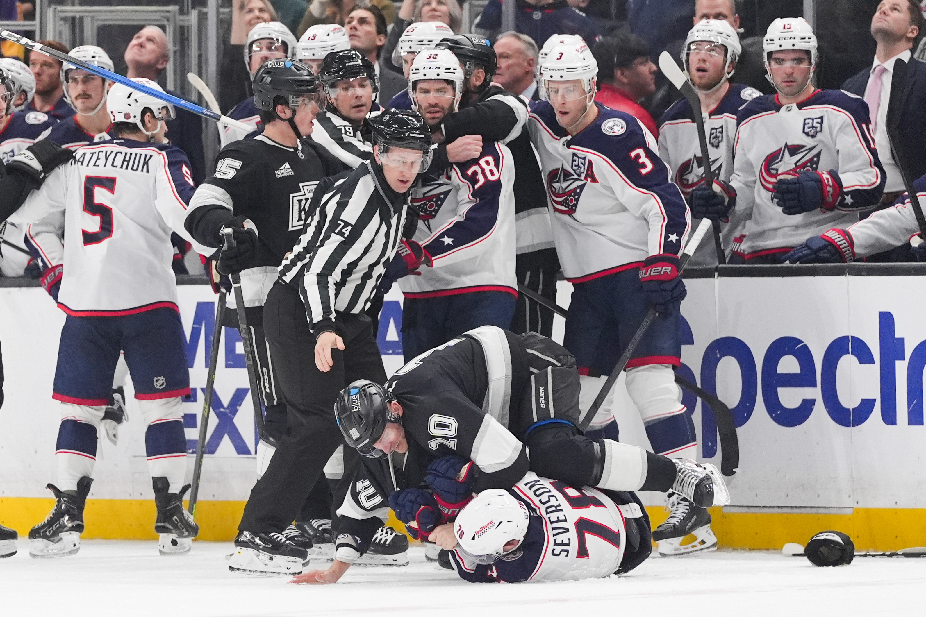 Columbus Blue Jackets defenseman Damon Severson (78) is pinned to...